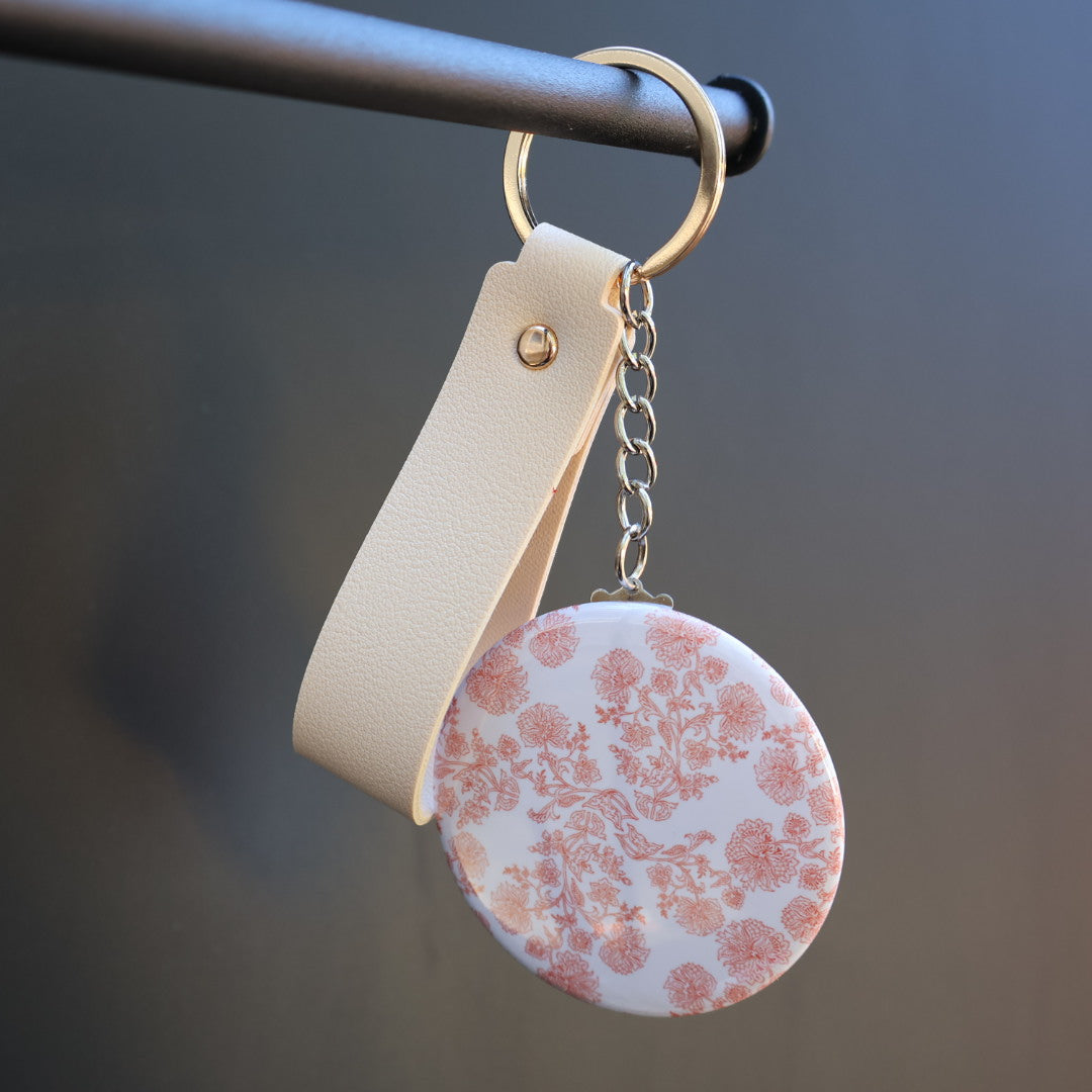 Keychain with floral design on a plain background